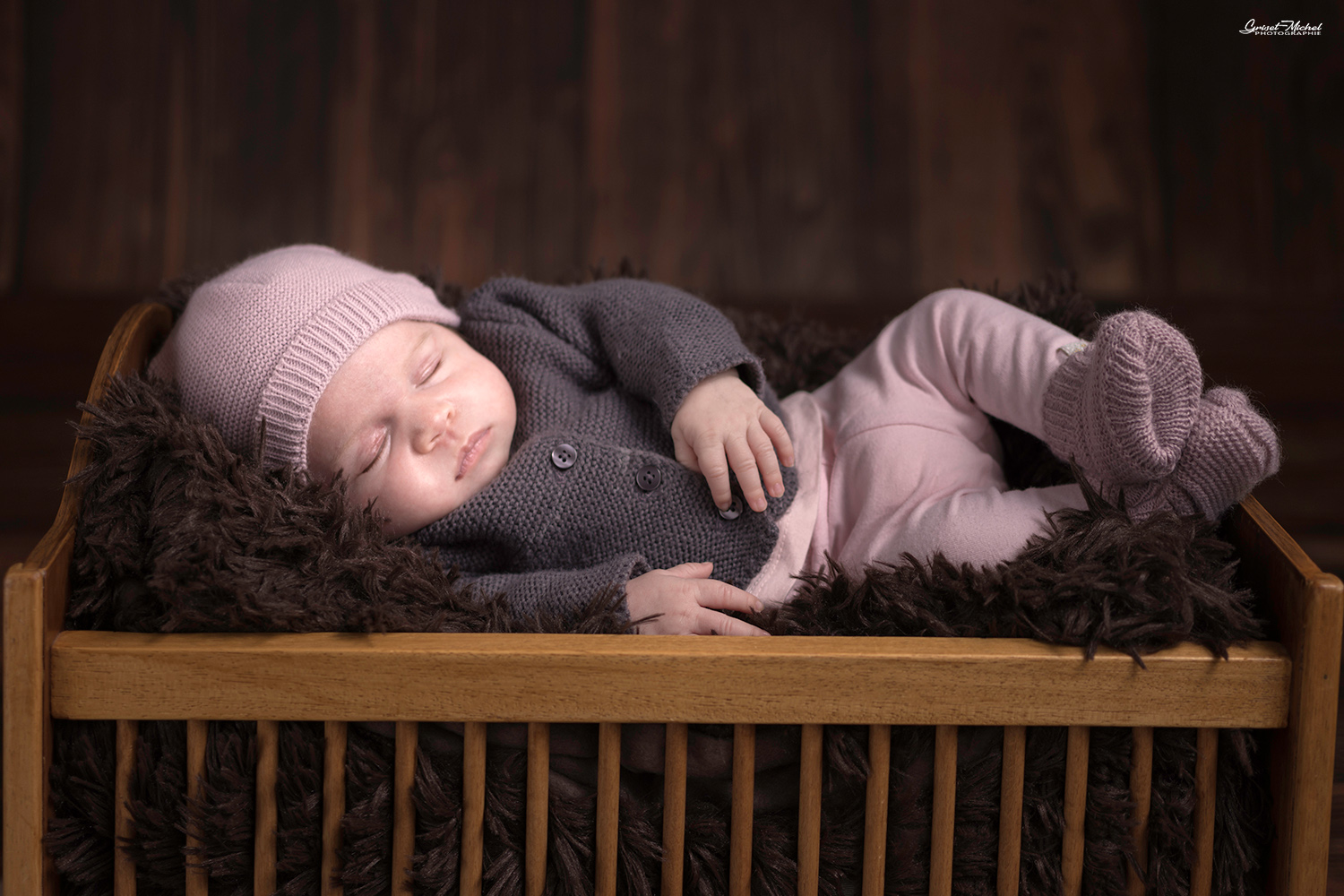 une petit fille de 1 mois qui dort dans un petit lit